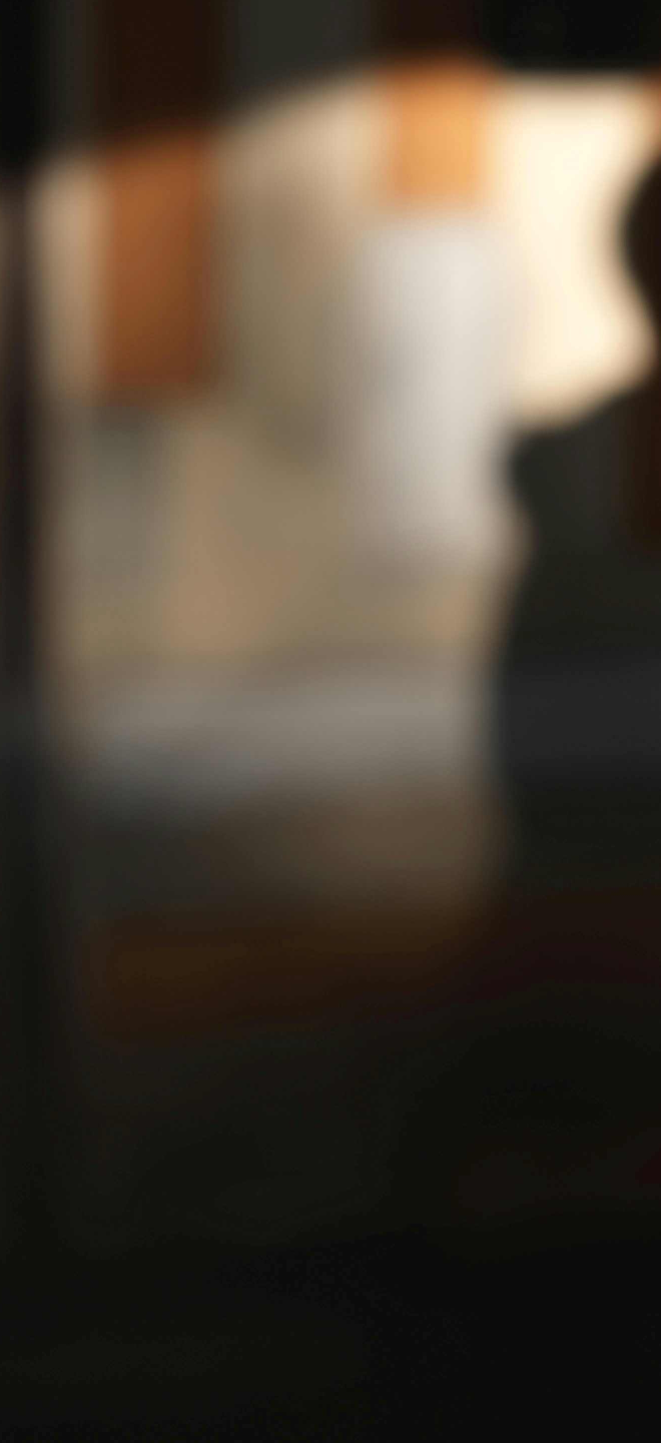 Blurred picture of an individual outside a lit up arcade